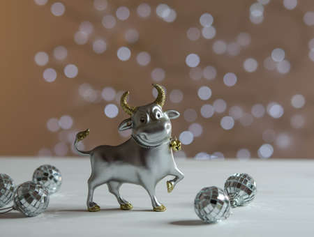 Bull and mirror balls on a black top. Christmas decorationsの写真素材
