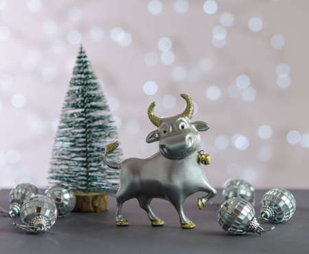 Christmas tree, bull and mirror balls on the table. Christmas decorationsの写真素材