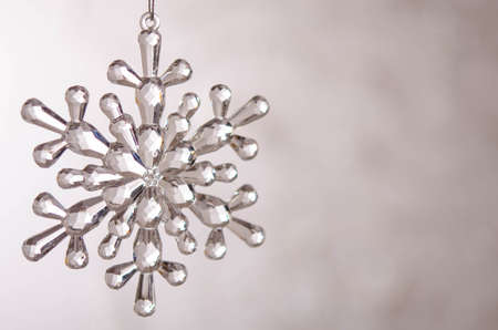 Transparent toy snowflake. Bokeh. Silver Christmas lights. Christmas decorationの写真素材