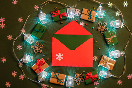 Frame from a garland and a red envelope on a green background. New Year decoration.の写真素材