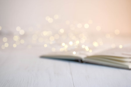 An open book and a garland on the table. Christmas decorationsの写真素材