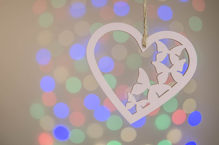 Wooden heart and colored bokehの写真素材