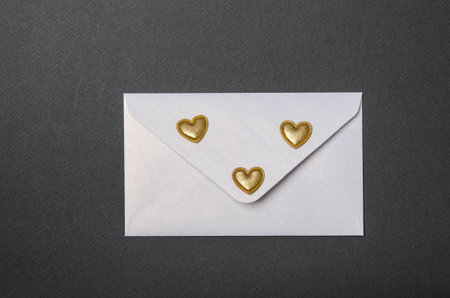 white envelope, golden hearts and black top