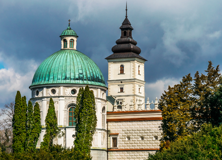 Grand Castle in Poland, Europe. A beautiful white stone castle with towers and sharply angled roofs with green lawn and the way to plan and cloudy blue sky in the background. Architecture Europe.のeditorial素材