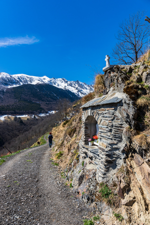 Saint-Lary-Soulan road mountain landscape in france yellow flowersの写真素材