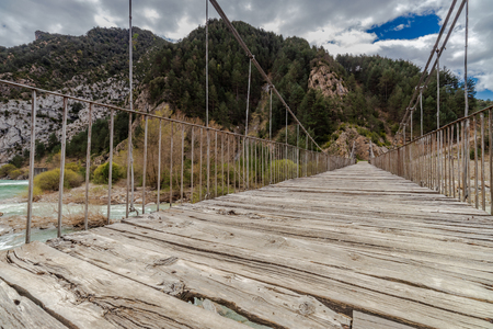 suspension bridge over the wild river in spainの写真素材