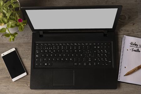work at home with computer with phone notebook plantの写真素材