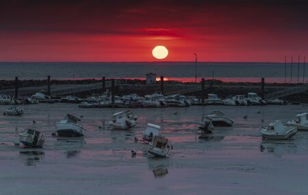 sunset on the french coast real big red sunの写真素材
