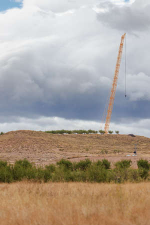 crane for the construction of a wind turbine in the middle of the field