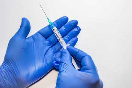 hands handling the coronavirus vaccine or covid-19, medical and sanitary equipmentの写真素材