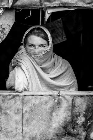 Portrait of a young European girl pretending to be trapped in Kabul. Black and white photographyの写真素材