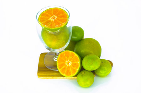 Orange fruit on tray and in clear glass.の写真素材