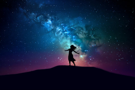 Silhouette of woman in night sky with stars and nebula. Generative AI.の素材