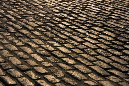 An ancient cobblestone road near sunset.の写真素材