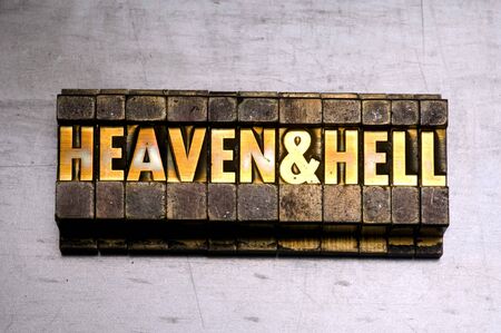 Brass / Gold colored letterpress piece on silver metal backgroundの写真素材