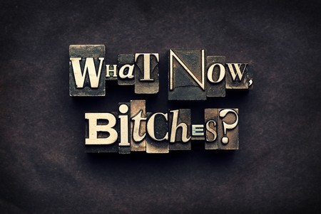 The phrase What Now, Bitches? photographed using vintage letterpress type and cross processed for a unique look.の写真素材