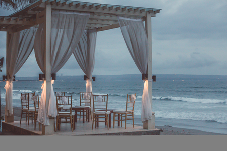 Luxury beach bed during dusk with ocean viewの写真素材