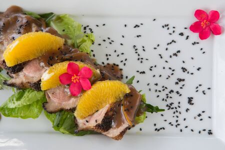 Roasted duck breast with oranges and orange sauce top viewの写真素材