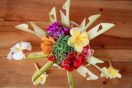 Traditional balinese offerings to gods in bali with flowersの写真素材