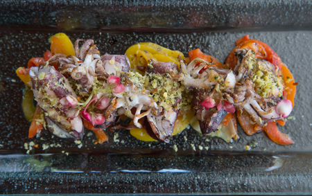 Freshly prepared tasty octopus squid with vegetables and spices