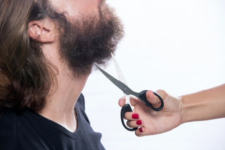 Beard styling and cut. Close up of a styling a beard. Advertising and barber shop concept isolated on white backgroundの写真素材