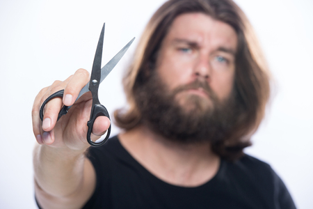 Beard styling and cut. Close up of a styling a beard. Advertising and barber shop concept isolated on white backgroundの写真素材