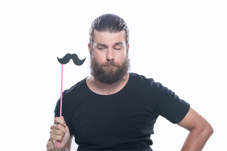 Photo booth fun. Man holding paper party sticks isolated on white background