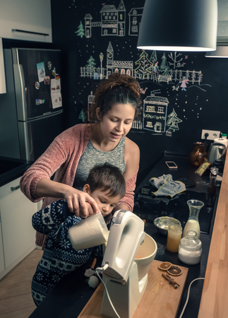 Mother and child making Christmas cookies and having fun. Christmas and New Year conceptの写真素材
