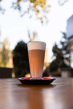 Iced latte coffee glass on wooden table in restaurant and cafeの写真素材