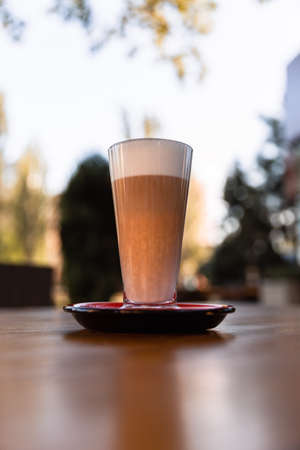 Iced latte coffee glass on wooden table in restaurant and cafeの写真素材