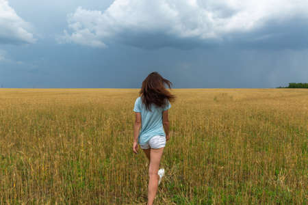 Young Woman In Wheat Field At Summer