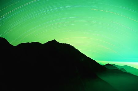 It is the star traces with black mountain.の写真素材