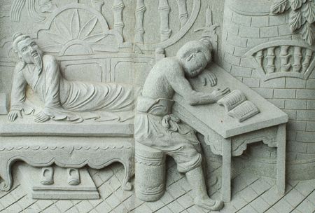 Chinese fable about filial piety by stone carving in temple.の写真素材