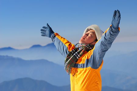 asian climber enjoy sunshine with beautiful mountain scenery.の写真素材