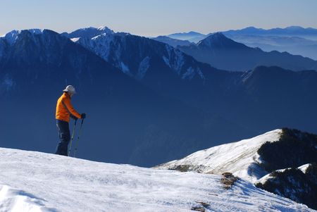 Asian skier stand on snow mountain slope.の写真素材