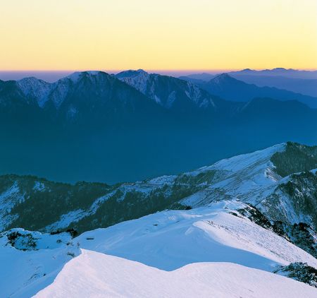 tranquil snow mountain scenery with sunset color.