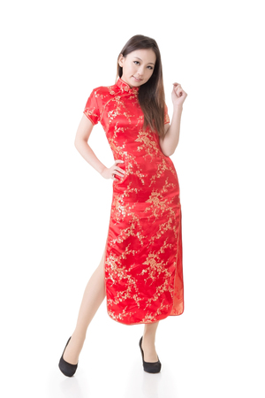 Chinese woman dress traditional cheongsam at New Year, studio shot isolated on white background の写真素材