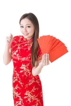 Attractive Chinese woman dress traditional cheongsam and hold red envelope, closeup portrait on white background の写真素材