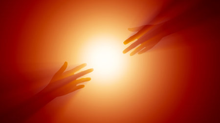 Silhouette of human hands reaching for the sun on orange backgroundの写真素材
