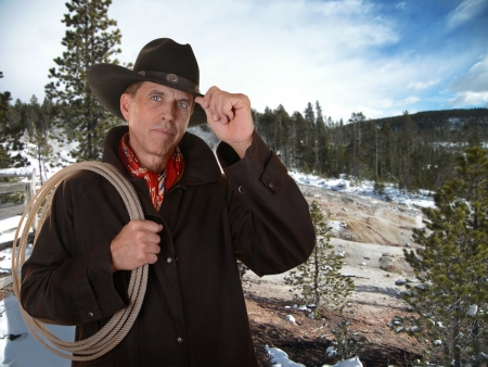 Cowboy with lariat against a winter background の写真素材