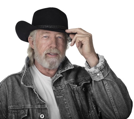 Handsome mature man wearing a gray jeans jacket and black felt cowboy hat with blue eyesの写真素材