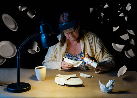 conceptual image representing a mother repairing all that is broken late into the nightの写真素材