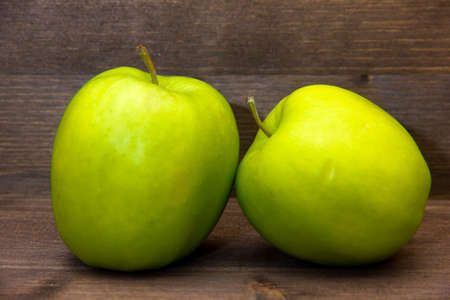 Apples on wooden walnut close up views の写真素材