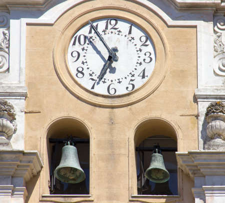 Bell tower with clock seen up close 