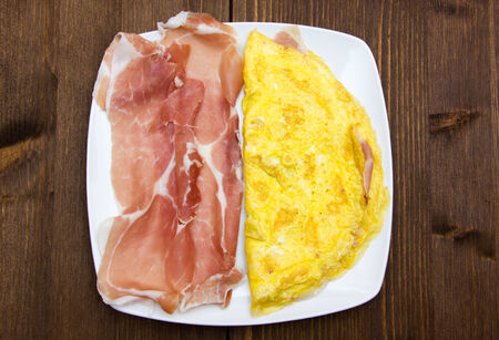 Omelet with ham top view on a wooden tableの写真素材