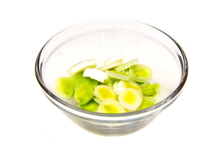 Bowl with sliced leek on a white backgroundの写真素材