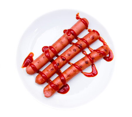 Sausages with tomato sauce on white background viewed from aboveの写真素材