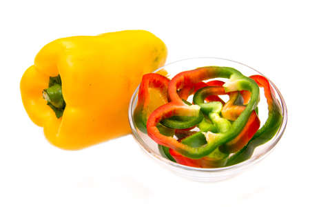 Pepper slices on bowl on white background
