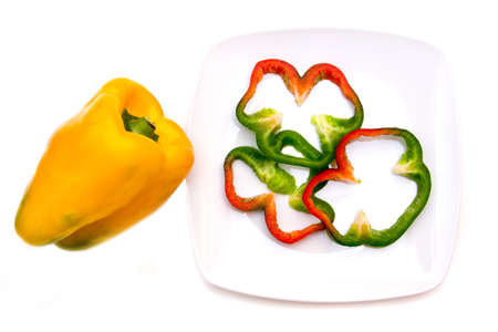 Pepper slices on plate on white background viewed from aboveの写真素材