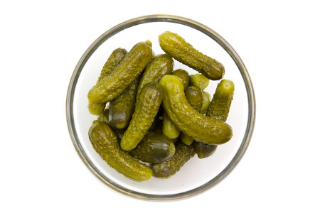 pickles on bowl on white background seen from aboveの写真素材